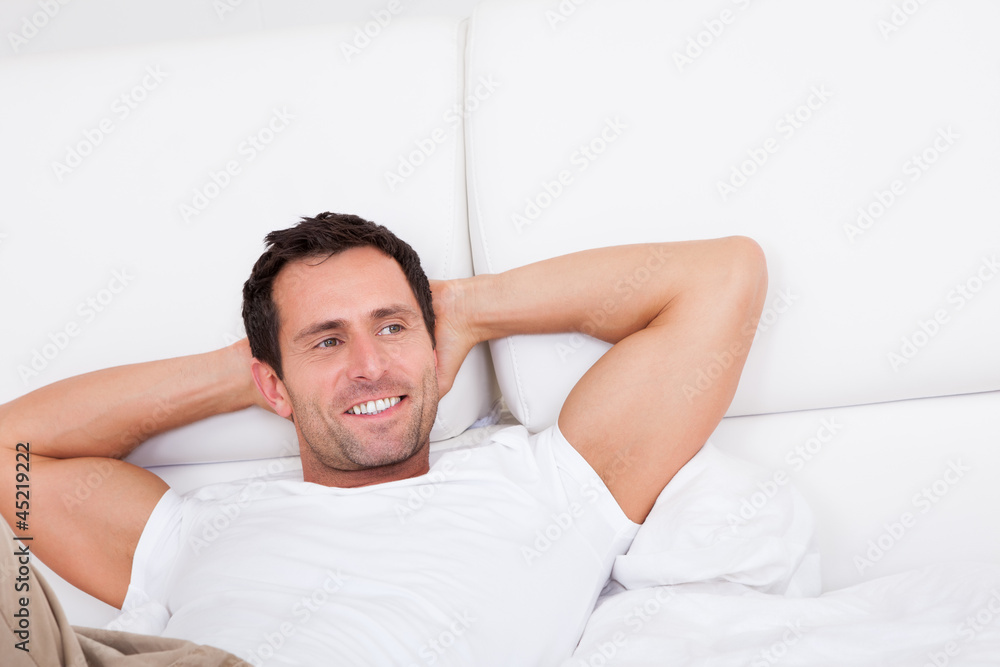 Portrait Of Young Man Relaxing On Bed Portrait Of Young Man Relaxing On Bed