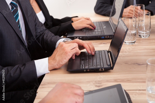 Businesspeople Using Laptop