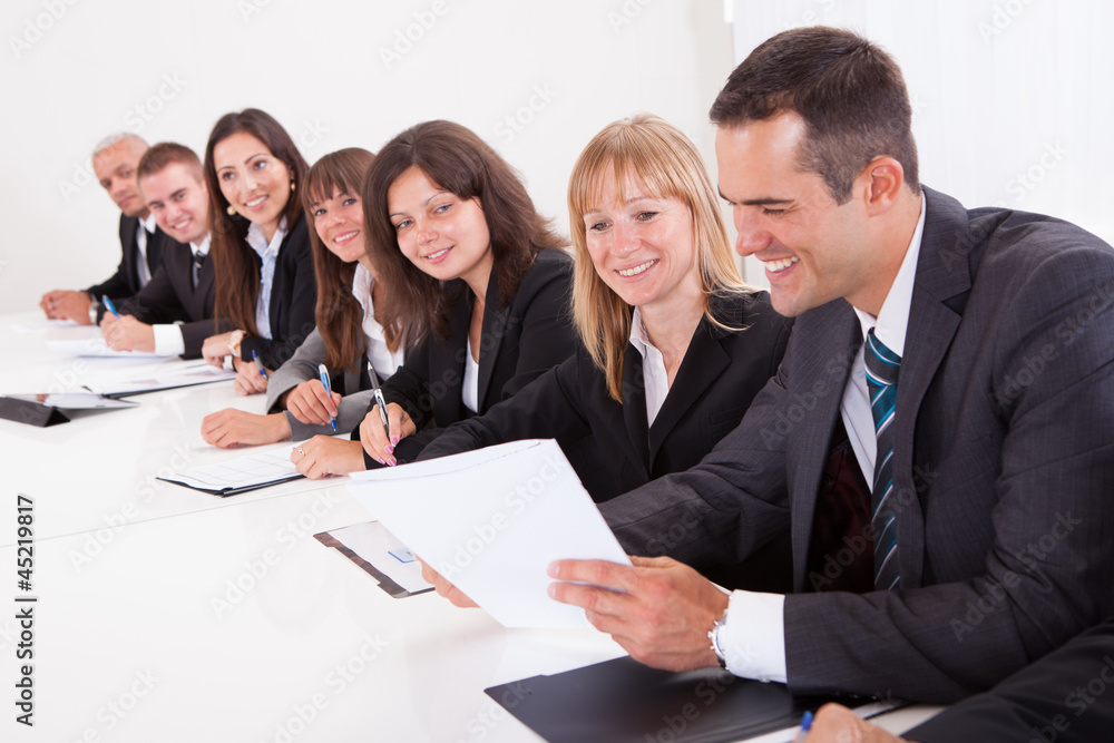 Businessman Showing Paper To His Colleagues Businessman Showing Paper To His Colleagues