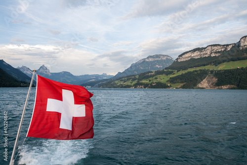 Swiss flag flutter above the lake