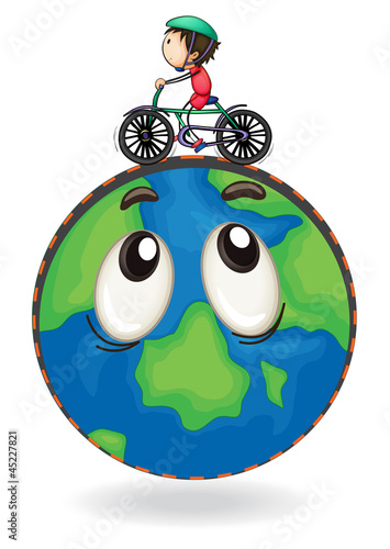 a boy riding on bicycle on earth globe