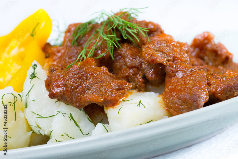 Beef stroganoff over boiled potatoes with pepper and dill Beef stroganoff over boiled potatoes with pepper and dill