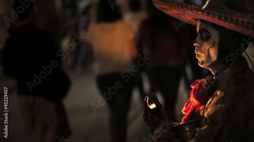 Man using makeup of a skull on the day of the dead