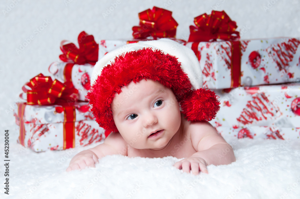 Newborn baby boy Santa Claus with Christmas gifts Newborn baby boy Santa Claus with Christmas gifts
