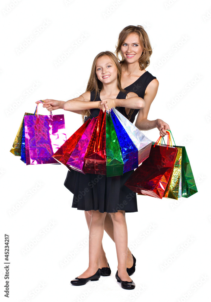 mother and daughter in elegant  dresses  with many colorful bags