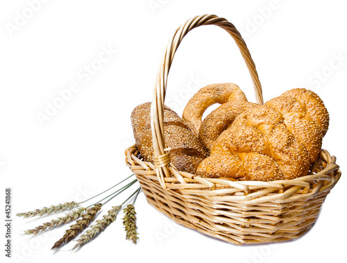 Basket with bread on white background