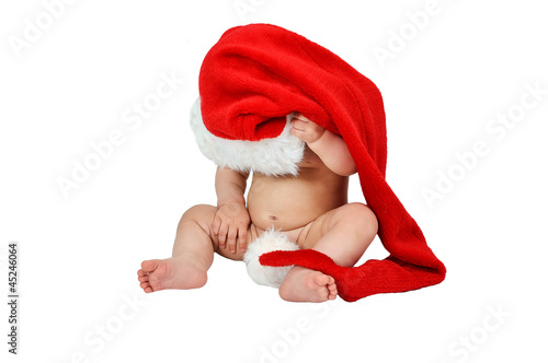 Adorable child iwearing red Christmas cap photo