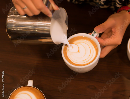 Hand pouring milk to do Latte art