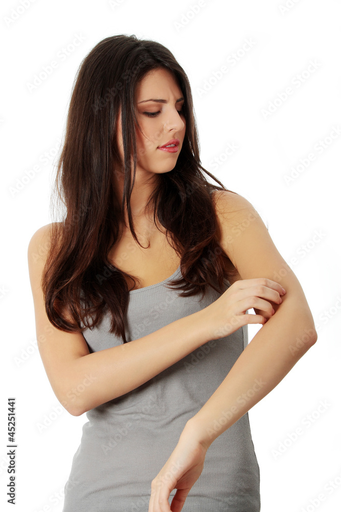 Young beautiful woman scraching her self.
