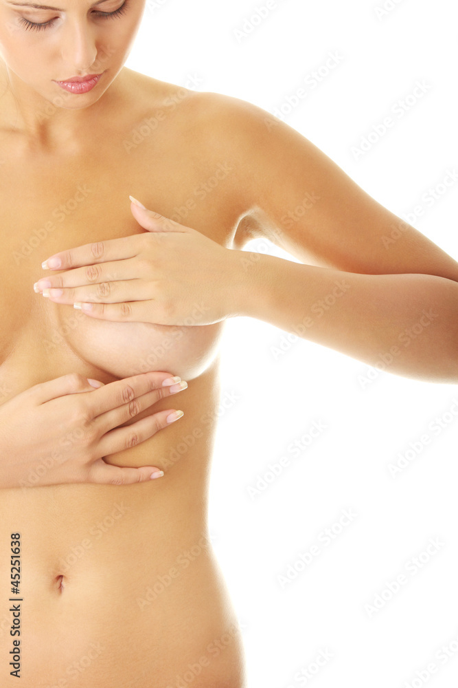 Woman examining her breast for lumps or breast cancer Woman examining her breast for lumps or breast cancer