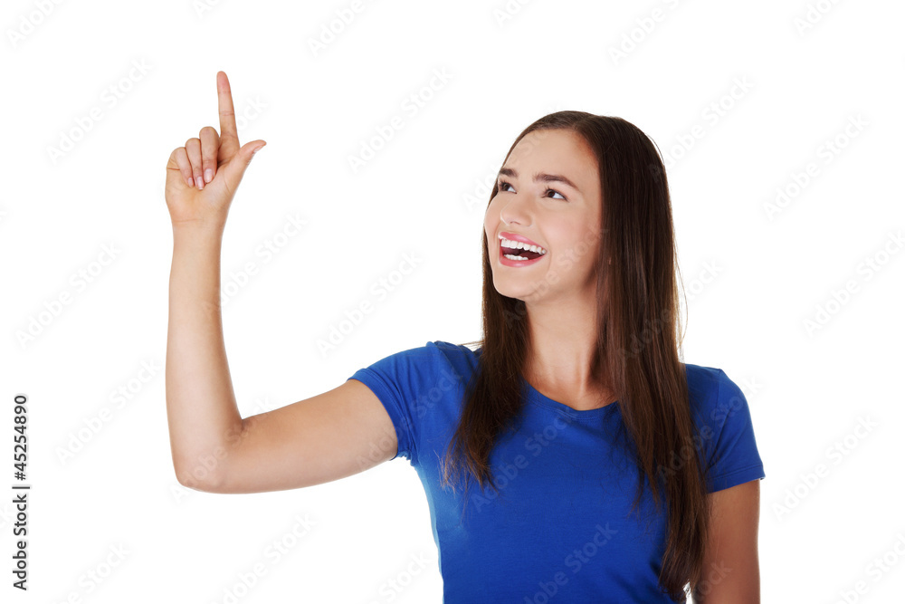 Happy , excited young woman pointing on copy space Happy , excited young woman pointing on copy space