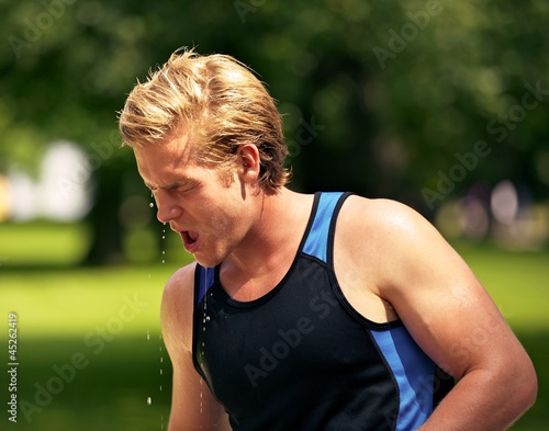 Young Athlete Refreshes Himself with Water