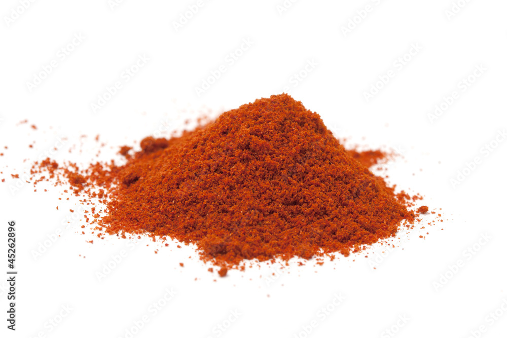 Pile of red paprika powder on white Pile of red paprika powder on white