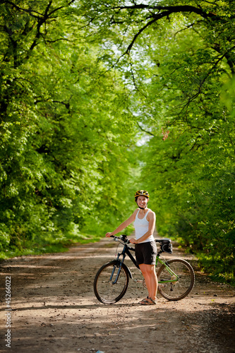 Biker on the forest road © Maygutyak