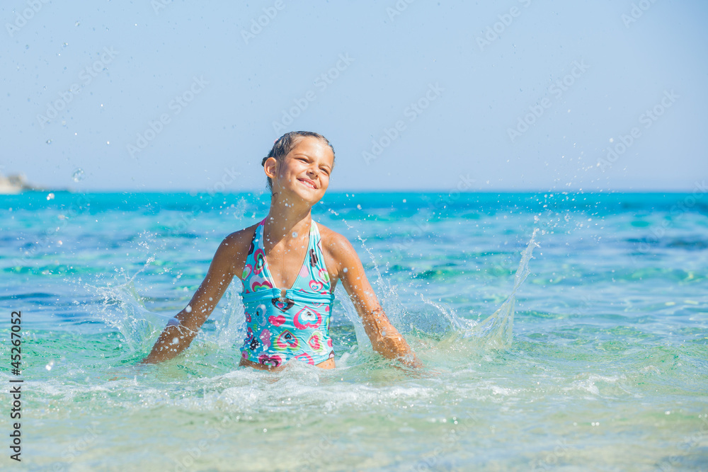 Young girl playing in the sea