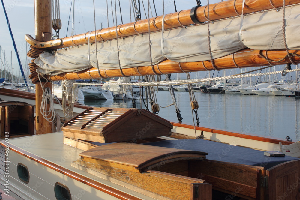 Fototapeta premium classic wood sailing yacht with mast sail deck and varnished hatch