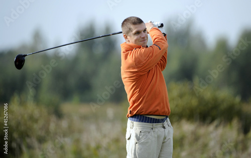Golf player strikes a good shot