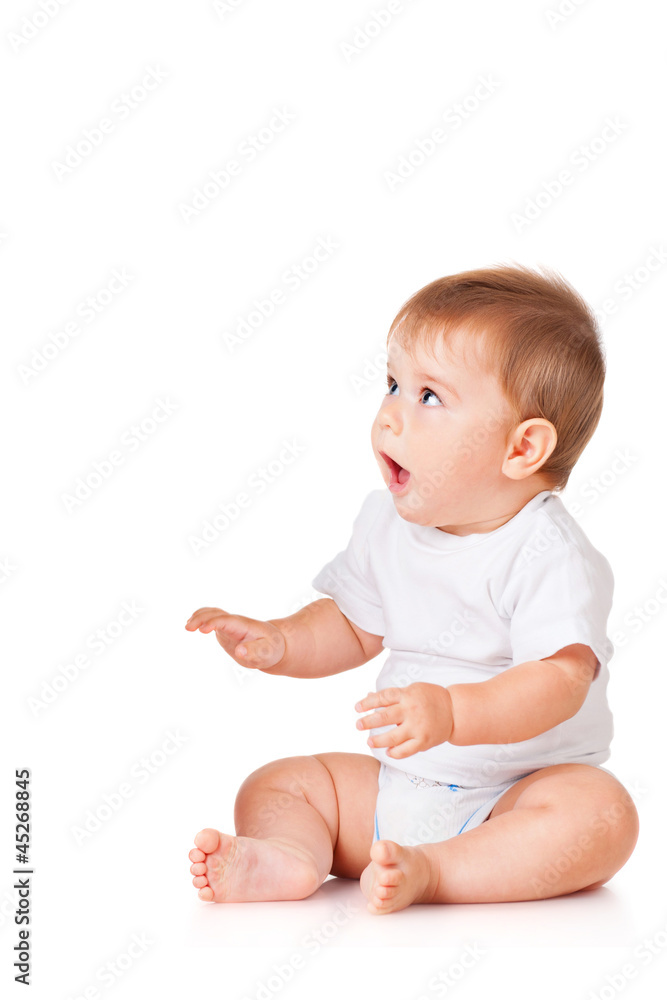 Baby is sitting on floor, isolated on white Baby is sitting on floor, isolated on white