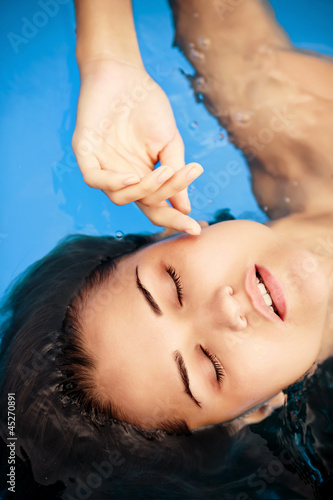Young woman beauty portrait in water