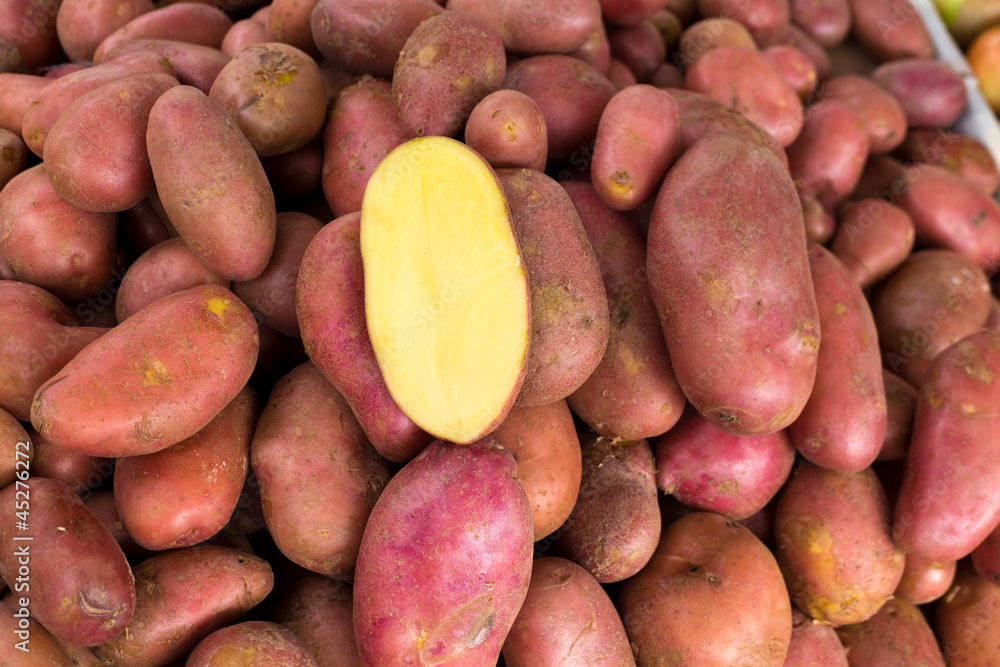Red potatoes in a market display with half cutted Red potatoes in a market display with half cutted