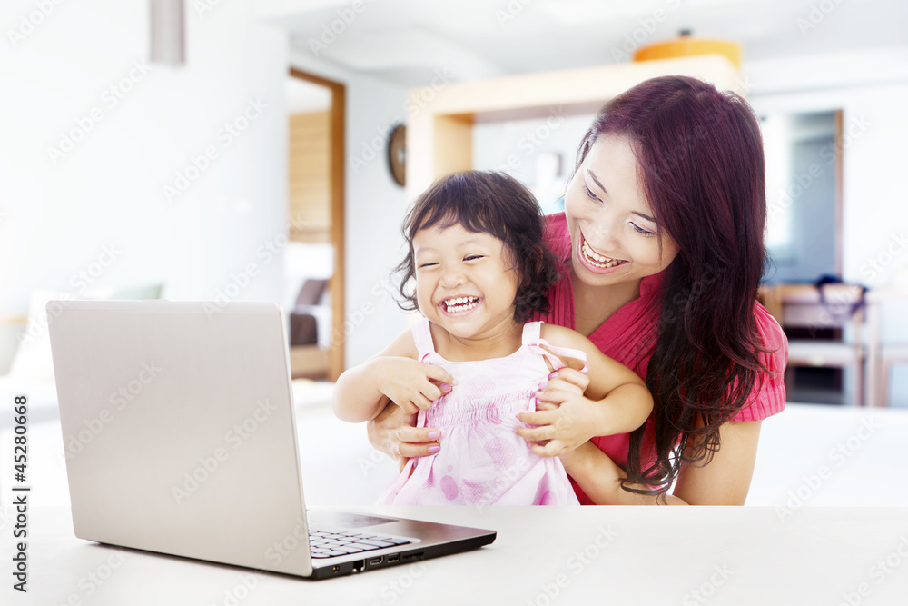 Happy family with laptop at home Happy family with laptop at home