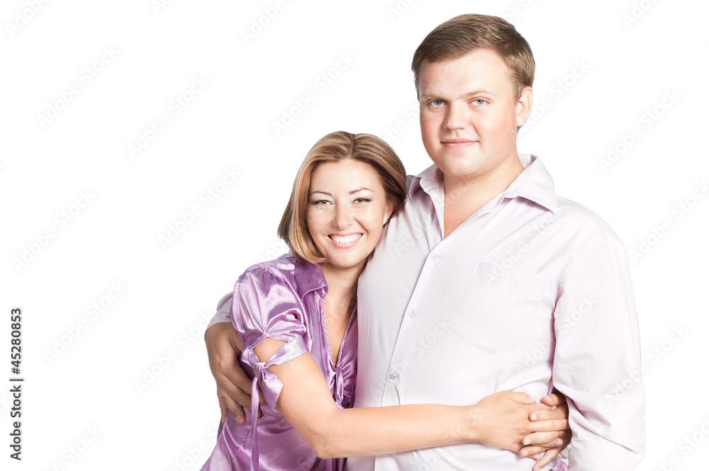 Portrait of happy young woman embracing her husband - isolated o Portrait of happy young woman embracing her husband - isolated o