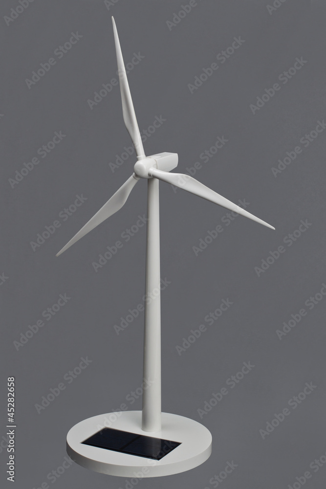 Modell einer Windkraftanlage auf Grauem Hintergrund Modell einer Windkraftanlage auf Grauem Hintergrund