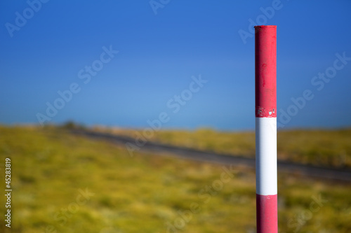 Snow road poles in high mountain blue sky