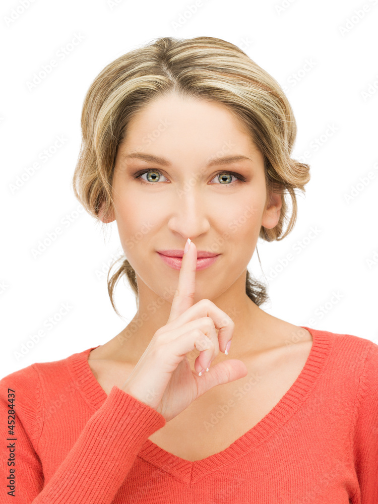 happy woman with finger on lips happy woman with finger on lips