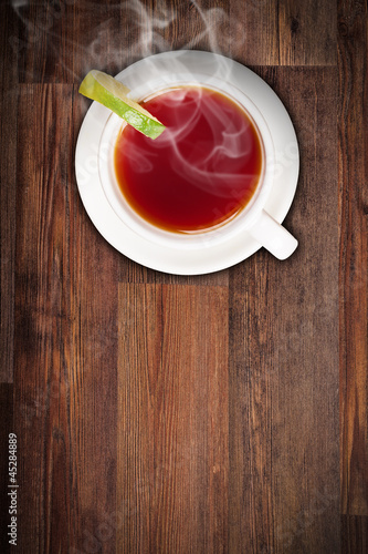 Top view of lemon tea on wooden plank table