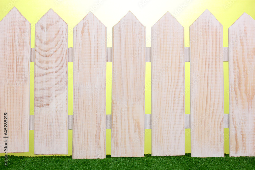 wooden fence and green grass on green background. wooden fence and green grass on green background.