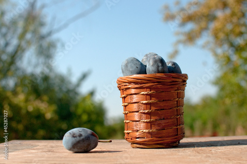 Plum on table and a punnet