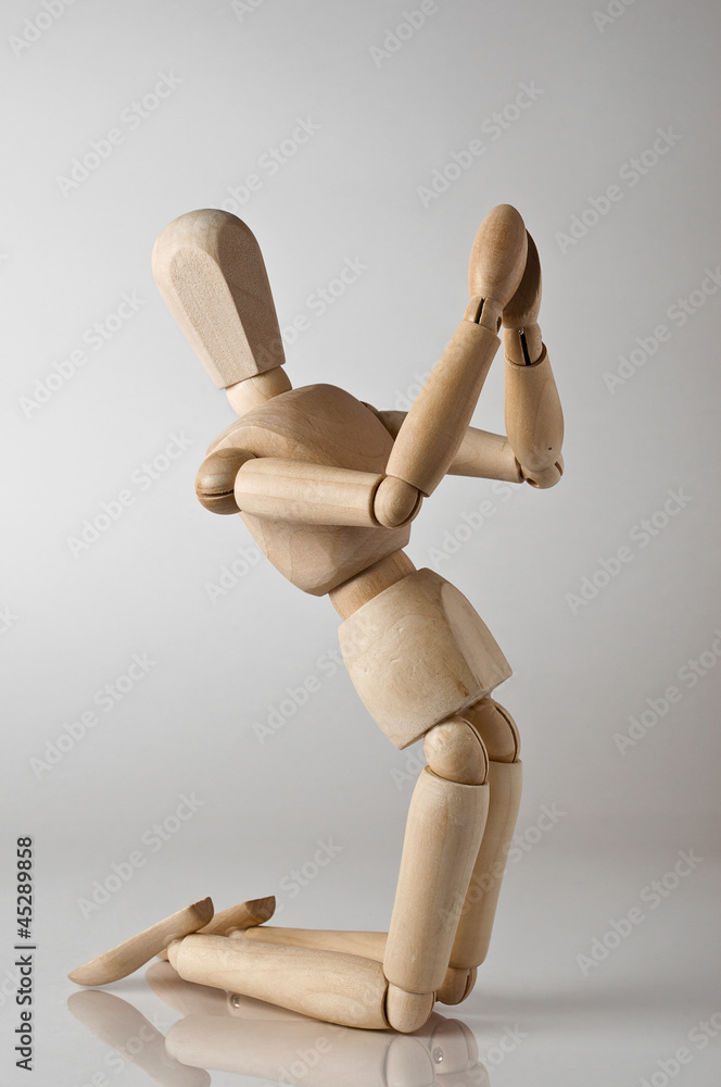 wooden man praying