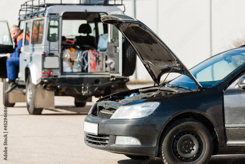 Repairing service man with damaged car trouble Repairing service man with damaged car trouble