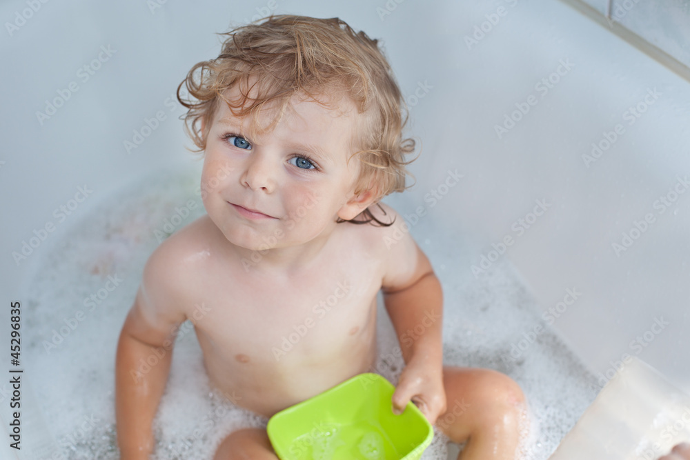 Adorable toddler taking bath