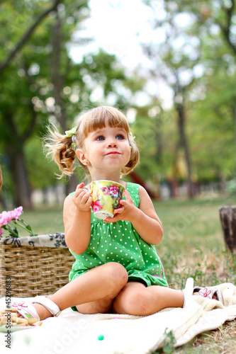 Caucasian little girl eating sweets