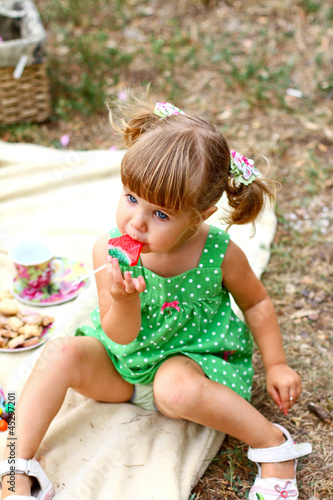 Caucasian little girl eating sweets