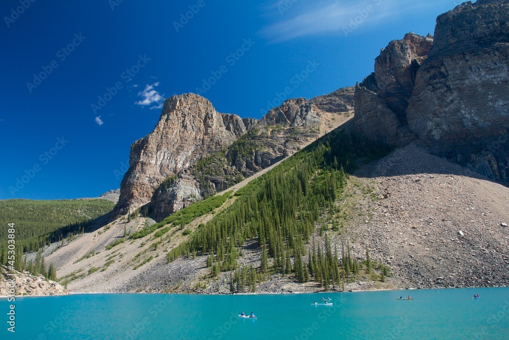 Canoes and tourists on beautiful Moraine Lake, Canada