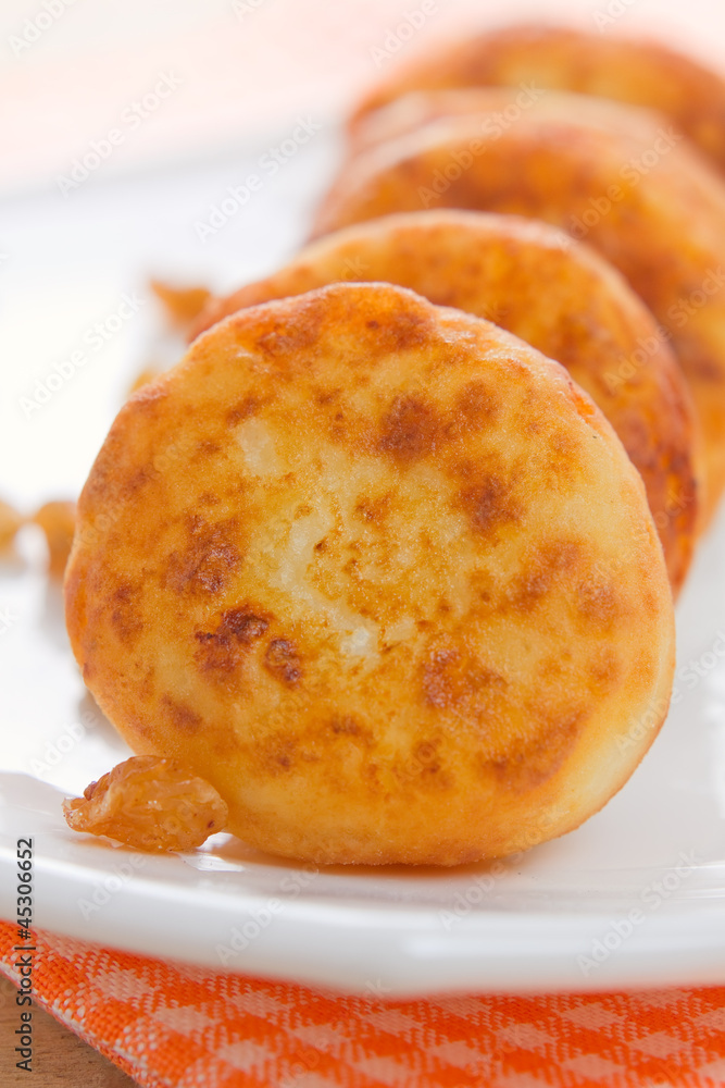 Homemade sweet cheese pancakes with raisins Homemade sweet cheese pancakes with raisins