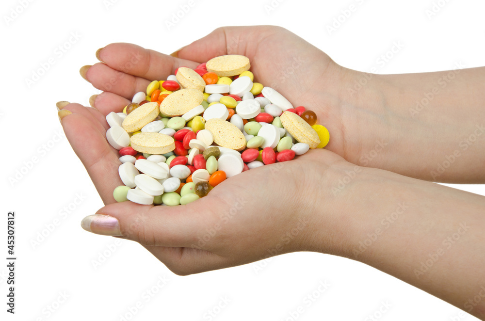 Hands holding pills on white Hands holding pills on white
