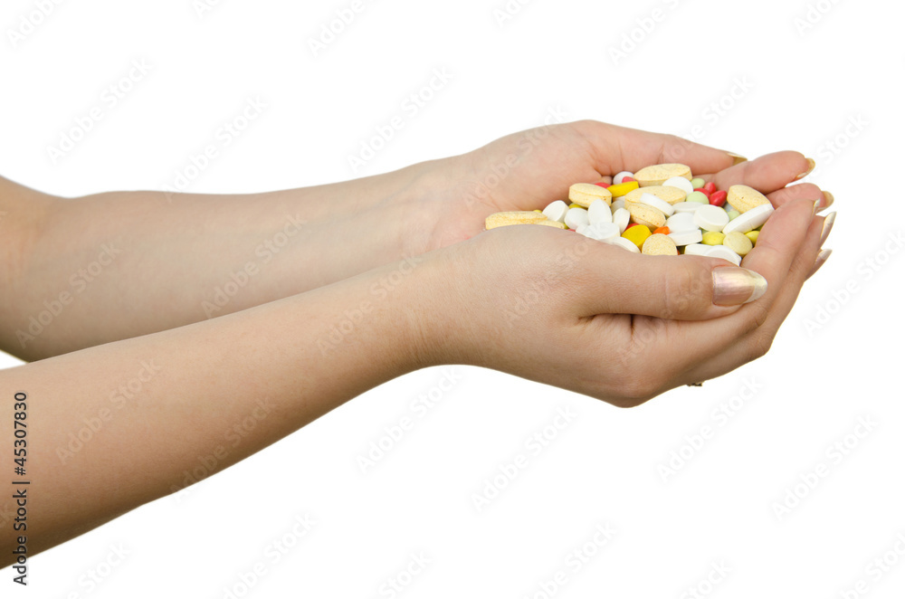 Hands holding pills on white Hands holding pills on white
