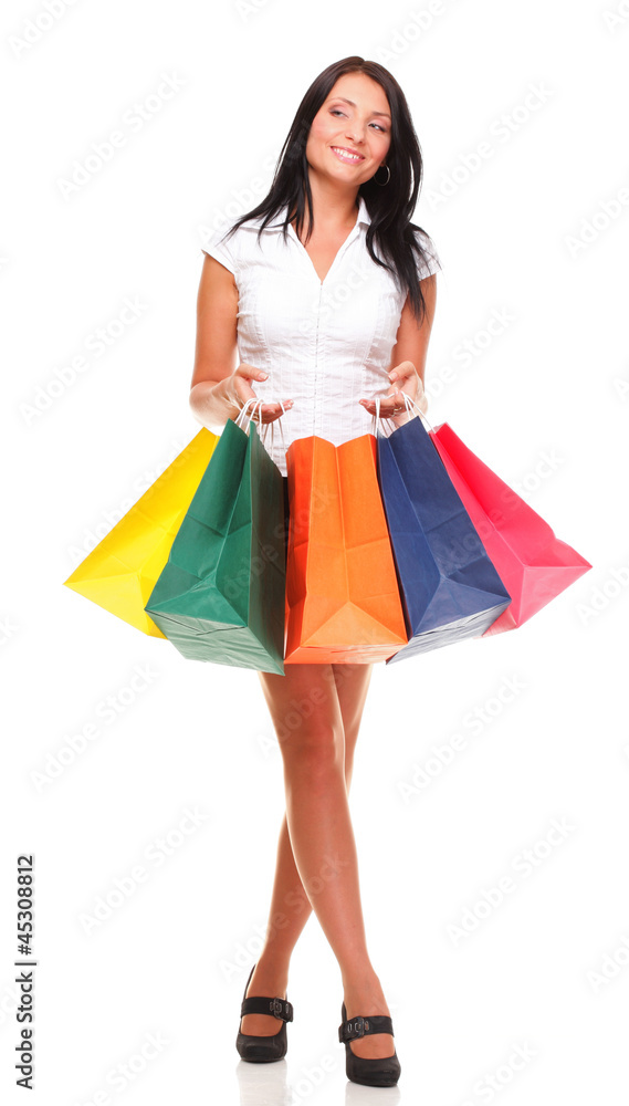 Portrait of young woman carrying shopping bags against white bac Portrait of young woman carrying shopping bags against white bac
