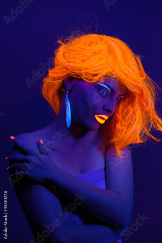 Uv light portrait, woman with glowing accessories and make up