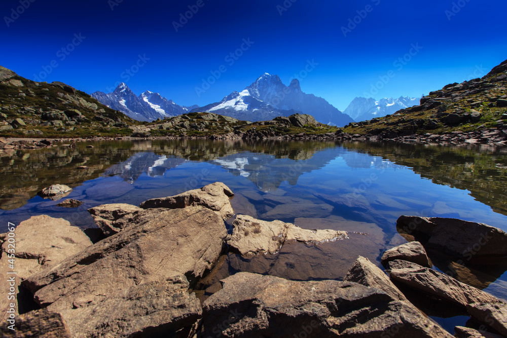 Mountain lake reflection in summer in the French Alps