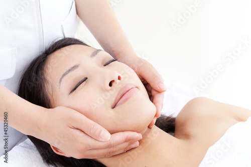 attractive asian woman on facial massage