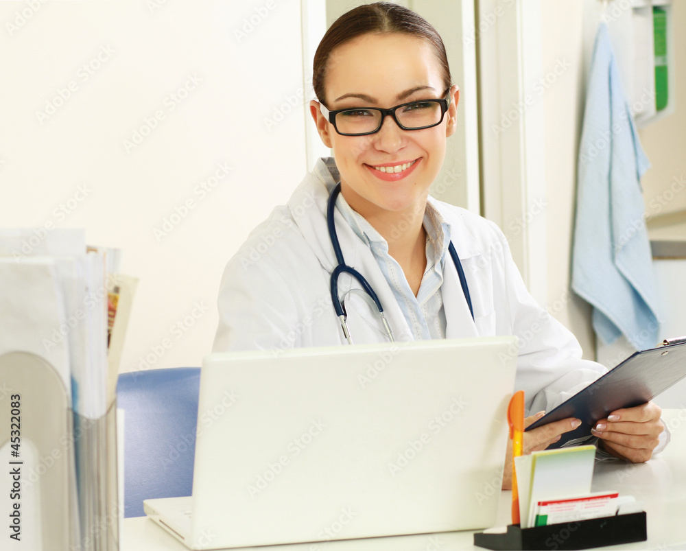Female doctor working at desk, isolated on white background Female doctor working at desk, isolated on white background