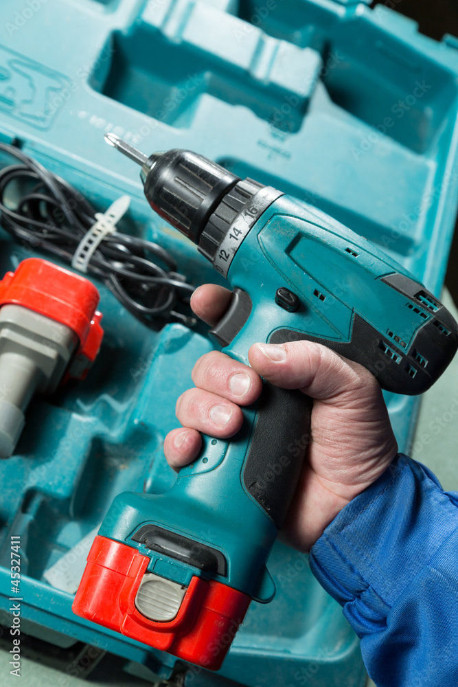 Male hand holding a screwdriver Male hand holding a screwdriver