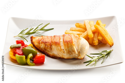 Grilled chicken breast, French fries and vegetables