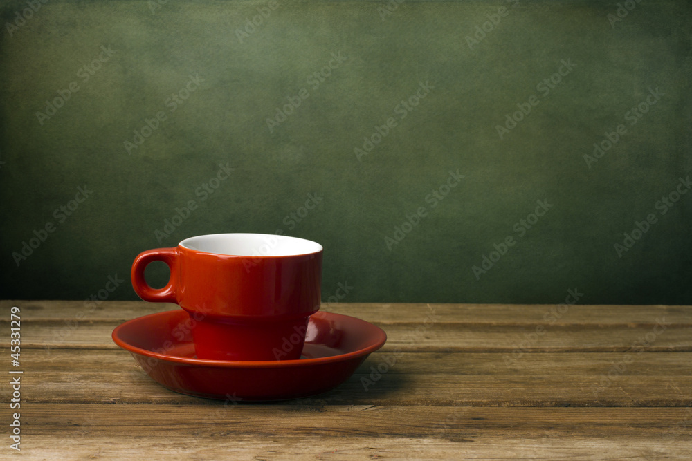 Background with red coffee cup on wooden table Background with red coffee cup on wooden table