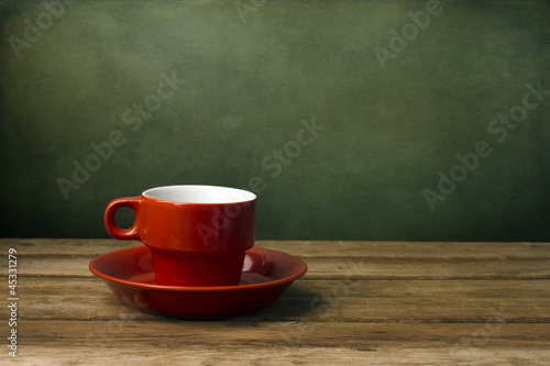 Background with red coffee cup on wooden table